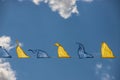 Yellow and blue triangular festival flags on sky background with white clouds. Outdoor Celebration Party Royalty Free Stock Photo