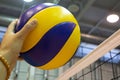 Yellow-blue volleyball on the floor in the gym Royalty Free Stock Photo