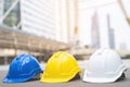 Yellow, blue and white hard safety wear helmet hat in the project at construction. workman as engineer or worker. Royalty Free Stock Photo