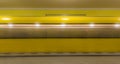 The yellow blurred underground train enters the subway station Royalty Free Stock Photo