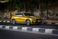 yellow BMW X2 driving fast on the road blurry in motion Royalty Free Stock Photo