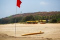 The yellow board of the rescuer for surfing lies on the sand used by the lifeguard working on the Arambol beach Royalty Free Stock Photo