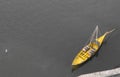 Yellow boat on black and white background. Yellow boat with wine barrels view from above . Boat on water top aerial view.