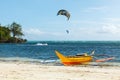 Yellow boat on blue tropical sea and kiters on ocean Philippiness