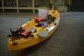 Yellow boat made of plastic. Canoe in garage. Sports equipment. Preparation for hike