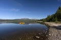 Yellow boat on tranquil lake with snow covered mountains Royalty Free Stock Photo