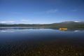 Yellow boat on tranquil lake with snow covered mountains Royalty Free Stock Photo