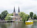 Yellow boat waits for bridge to open near oostpoort in old dutch