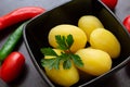 Boiled potatoes with chili peppers and tomatoes on a dark background Royalty Free Stock Photo