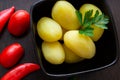 Boiled potatoes with chili peppers and tomatoes on a dark background Royalty Free Stock Photo