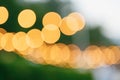 Yellow bokeh on a green background. Blurred background. Yellow circles of a defocused lens Royalty Free Stock Photo