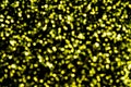 Yellow bokeh sprinkle on black abstract background. Birthday greeting or party invitation backdrop. Royalty Free Stock Photo