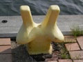 Yellow bollard on harbor quay