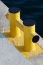 Yellow bollard pier - device for yacht mooring in marina Royalty Free Stock Photo