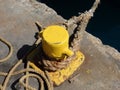 A yellow bollard in the windward islands.