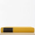 Yellow book with black frame on spine on the table