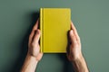 Yellow book cover mockup in hands