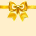 Yellow bow of silk ribbon, isolated on yellowish background