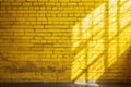 Yellow brick wall with shadow and sunlight, Abstract background, Copy space