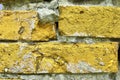 Yellow brick walls with old and weathered stones and cracks in high resolution Royalty Free Stock Photo