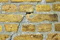 Yellow brick walls with old and weathered stones and cracks in high resolution Royalty Free Stock Photo
