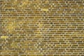 Yellow brick walls with old and weathered stones and cracks in high resolution