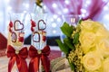 Yellow bride's bouquet with two wedding wine glasses decorated with hearts Royalty Free Stock Photo