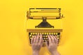 Yellow bright typewriter on a yellow background. Creativity concept Royalty Free Stock Photo