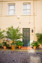 Yellow British house with plants outside the windows Royalty Free Stock Photo