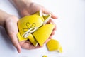 Yellow broken cup on white background. The concept of shattered happiness