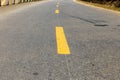 Yellow broken line on asphalt road