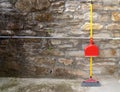 Yellow broom with the red dustpan.