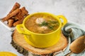 Yellow broth bowl with handles with delicious meatball soup with croutons and herbs on a wooden background, close-up Royalty Free Stock Photo