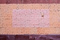 Yellow and brown brick wall with painted splotch