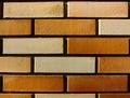 Yellow and brown brick wall pattern close-up detail with running bond. Royalty Free Stock Photo