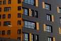 Yellow-brown modern ventilated facade with windows. Fragment of a new elite residential building or commercial complex Royalty Free Stock Photo