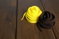 Yellow and brown shoelaces on wooden background. Space for text Royalty Free Stock Photo
