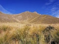 Yellow-brownish landscape of Southern Alps with blue sky