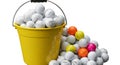A yellow bucket overflows with practice golf balls Royalty Free Stock Photo
