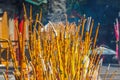 Yellow Buddhist prayer sticks burning in the censer at Po Lin Monastery, Lantau Island, Hong Kong