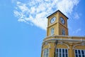 Yellow building with clock tower in Chino-Portuguese style on blue sky background, Phuket old town, Thailand Royalty Free Stock Photo