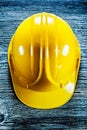 Yellow building helmet on wooden board Royalty Free Stock Photo