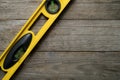 Yellow building level on the old wood table Royalty Free Stock Photo