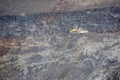 Yellow bulldozer on black volcanic soil