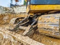 Yellow bulldozer excavator shoveling and digging the ground while working on the difficult excavation, new modern industrial Royalty Free Stock Photo