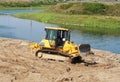 Bulldozer at work near river