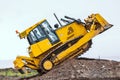 Yellow bulldozer overcome barrier Royalty Free Stock Photo
