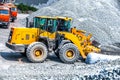 Yellow bulldozer working in quarry