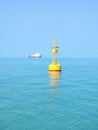 A yellow buoy in the deep blue sea