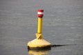 Yellow buoy in the river Hollandsche IJssel to characterize danger Royalty Free Stock Photo